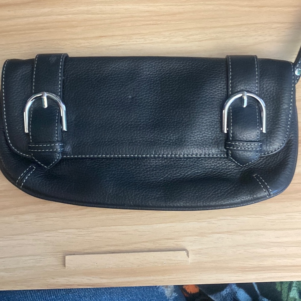 Black clutch like new, has a pink spot on the right hand side in the corner